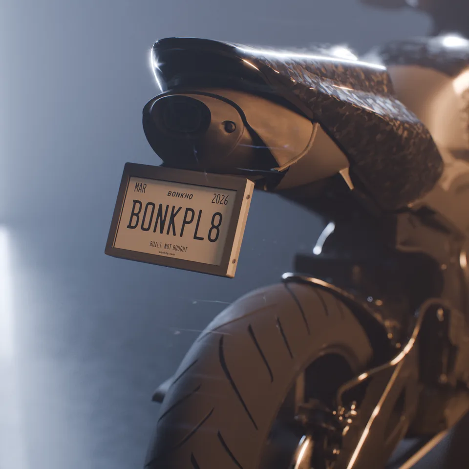 3D render of the BonkPlate prototype on a parked forged-carbon sportbike in studio light