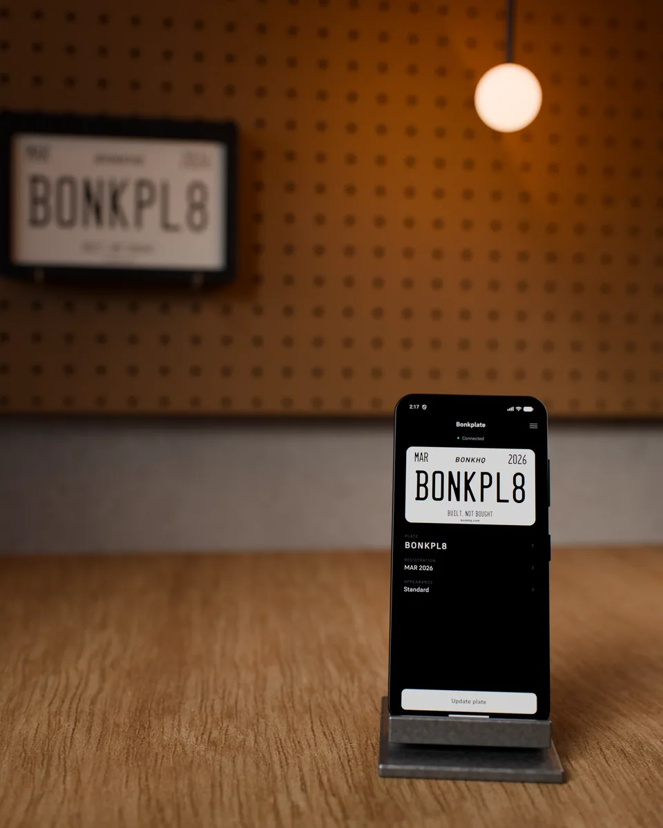3D render of BonkPlate behind a phone showing a BonkOS plate design